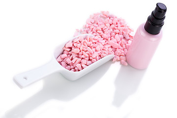 Image showing pink body lotion in dispenser and aroma salt isolated