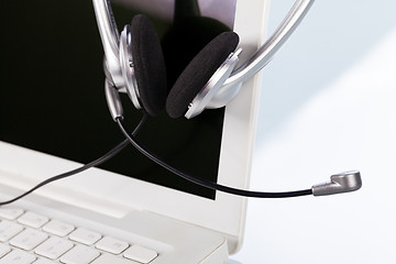 Image showing headset keyboard notebook laptop in office on table desk