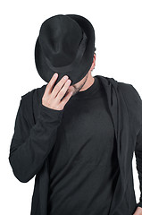 Image showing Man covers his face with his hat