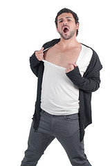 Image showing Man man ripping his shirt