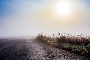 Image showing rural foggy road going to the sunrise