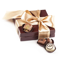 Image showing brown box with candies and golden tape
