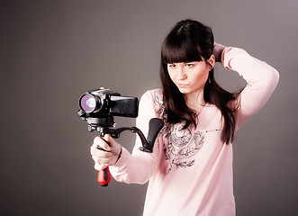 Image showing young woman with video camera