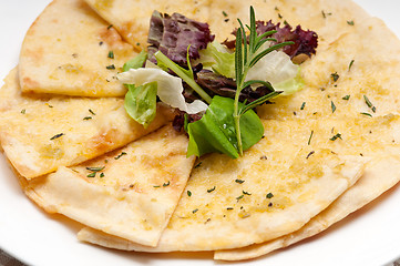 Image showing garlic pita bread pizza with salad on top