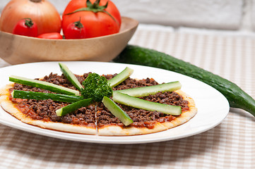 Image showing Turkish beef pizza with cucumber on top