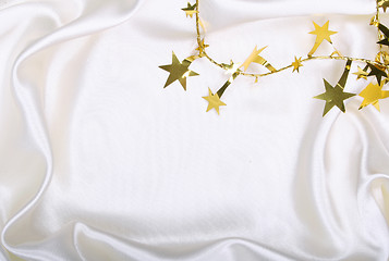 Image showing Golden stars and spangles on white silk