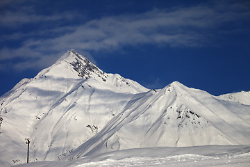 Image showing Ski slope and blue sky with clouds at sunny day