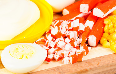 Image showing sliced crab sticks,mayonnaise, corn and egg on bamboo cutting board