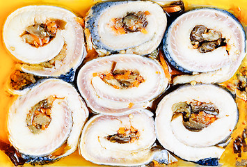 Image showing korean rolls on slices of salt  herring  as background