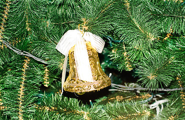 Image showing Gold Christmas bell and green spruce branch 