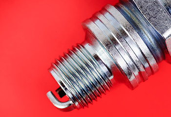Image showing spark-plug on the red background 