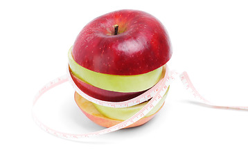 Image showing Healthy eating and diet concept:Green and red sliced apple with tape on white background 