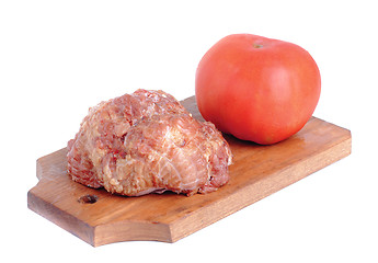 Image showing Meat product.and tomato   on a cutting board on white