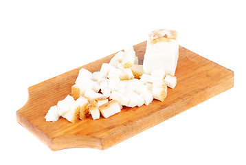 Image showing Sliced pig lard on cutting  board isolated on  white 