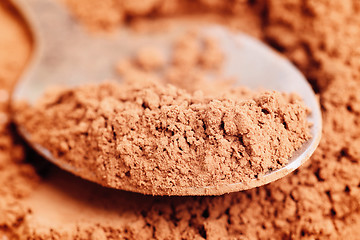 Image showing Cocoa  powder  and  steel  spoon