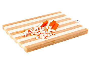Image showing sliced crab sticks on  cutting board