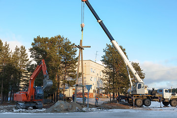 Image showing Installing a power pole with the use of special equipment