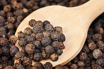 Image showing black pepper on wooden spoon as food  background