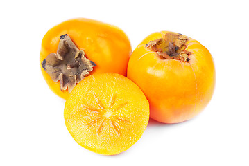 Image showing Persimmon fruit whole and sliced on white background