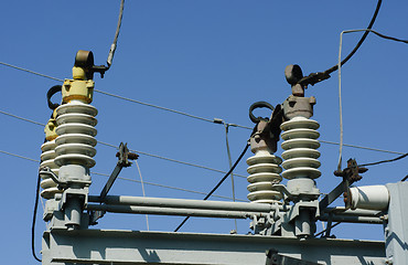 Image showing part of high-voltage substation on the blue sky background 