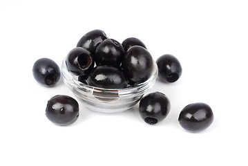 Image showing Black pitted olives in glass isolated on white macro 