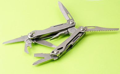 Image showing multitool isolated ower green background 