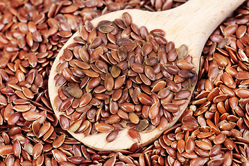 Image showing close up of flax seeds and  wooden spoon food background