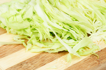 Image showing Green  cabbage sliced  on  cutting  board