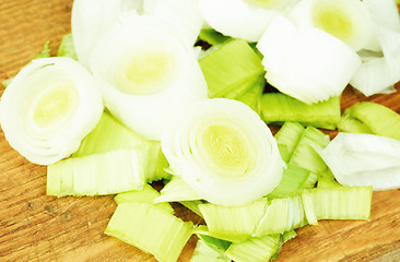 Image showing Fresh leek on  cutting board as food background