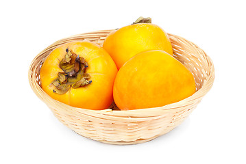 Image showing Persimmon fruit in fruit basket on white background