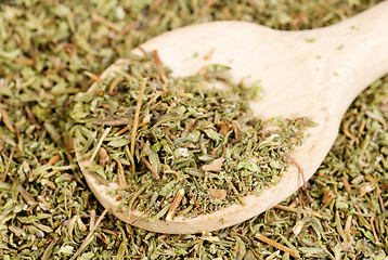 Image showing herb thyme and wooden spoon as background 