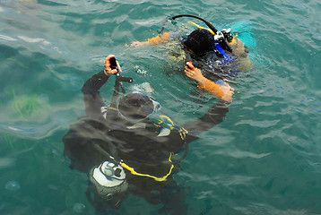 Image showing scuba divers scuba dive in sea