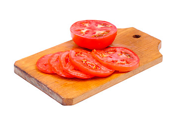 Image showing whole and sliced fresh red tomatoes on  cutting board isolated on white background 