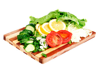 Image showing fresh fruits and vegetables on a bamboo cutting board