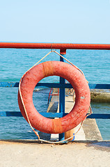 Image showing Red Lifebuoy in front of the blue sea