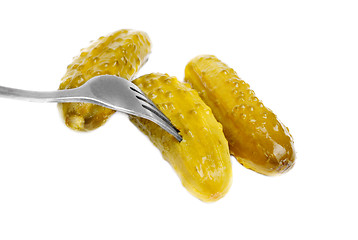 Image showing Marinated cornichons on the fork isolated on the white background