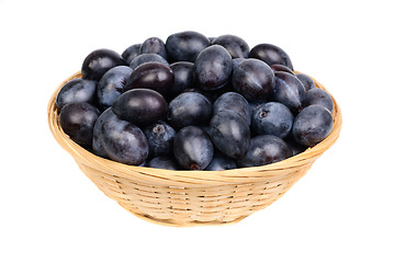 Image showing fresh blue plums in Fruit Basket on the white background 