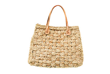 Image showing woman's handbag from natural straw  isolated  on  white