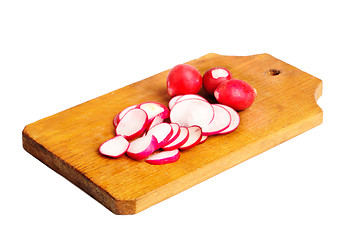 Image showing Fresh slised and whole radish on  cutting board  isolated on  white
