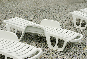 Image showing empty beach, sunbed on the pebble beach