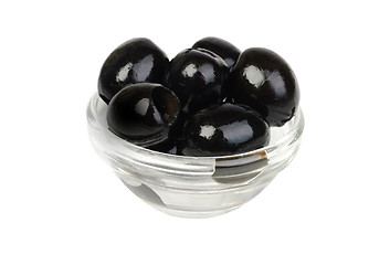 Image showing Black pitted olives in glass isolated on white macro 