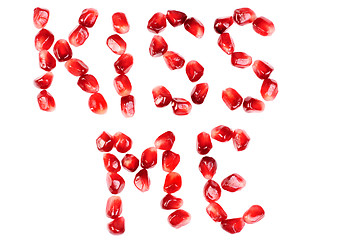 Image showing word of kiss me  from the seeds of a pomegranate isolated on  white