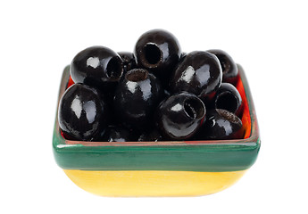 Image showing Black pitted olives in colored ceramic ware isolated  on  white