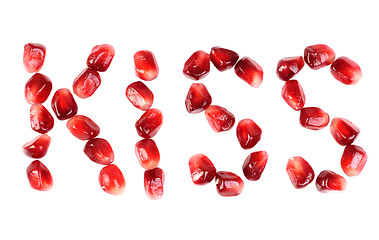 Image showing word of kiss  from the seeds of a pomegranate isolated on white 