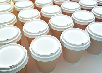 Image showing A row of paper coffee cups on a white background.