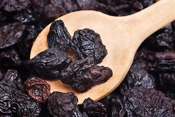 Image showing raisins and  wooden  spoon close- up food background 