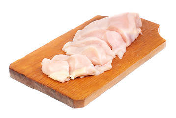 Image showing chicken meat sliced   on  cutting  board isolated  on  white  background