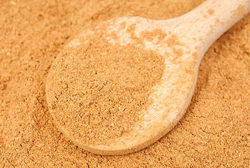 Image showing Cinnamon  powder and wooden spoon as  nature  food   background