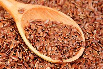 Image showing close up of flax seeds and wooden spoon food background