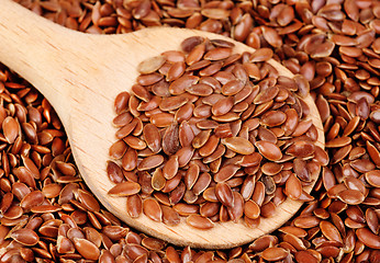 Image showing close up of flax seeds and  wooden spoon food background